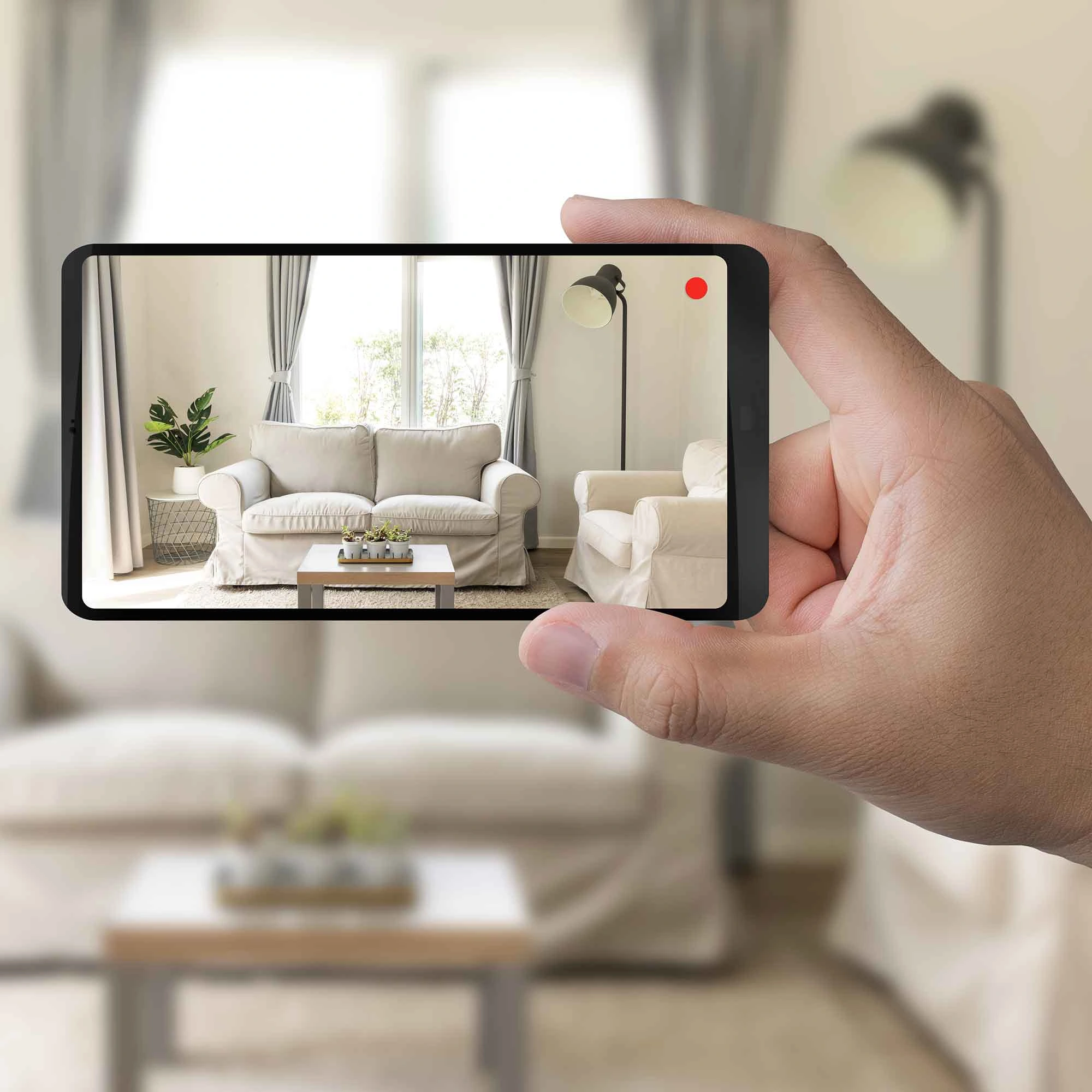 A smartphone in hand reveals a virtual room